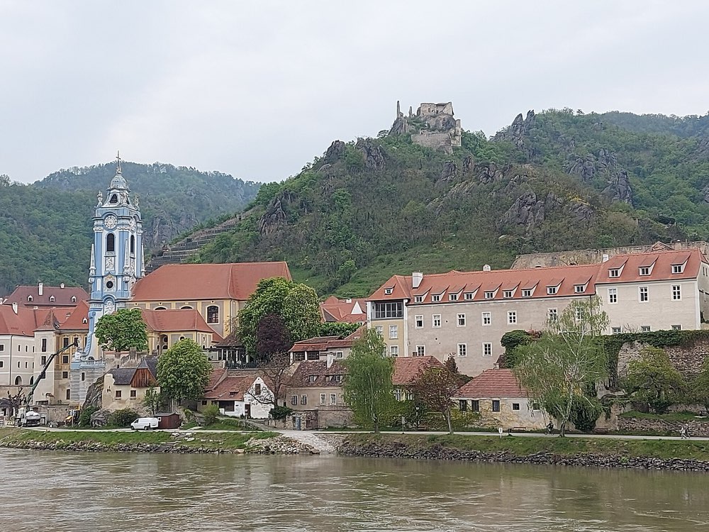 The blue church tower and red roofs of Dürnstein beside the Danube in the Wachau, Austria